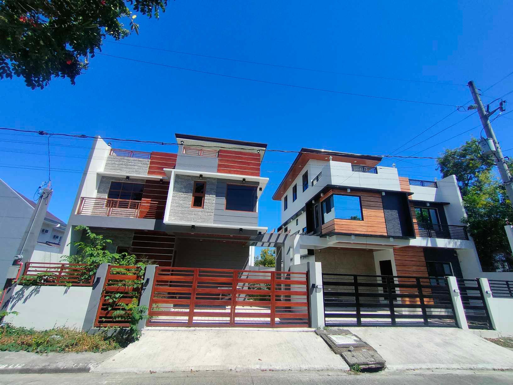 Two houses are sitting next to each other on a sunny day.
