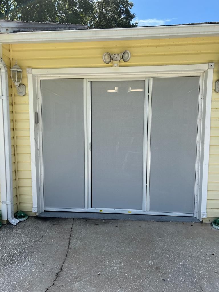 A yellow house with a gray garage door and a white trim.
