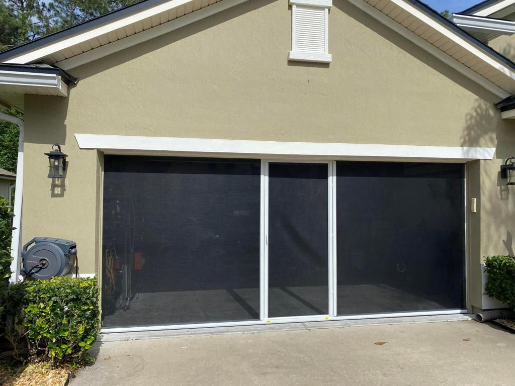A house with a screened in garage door.