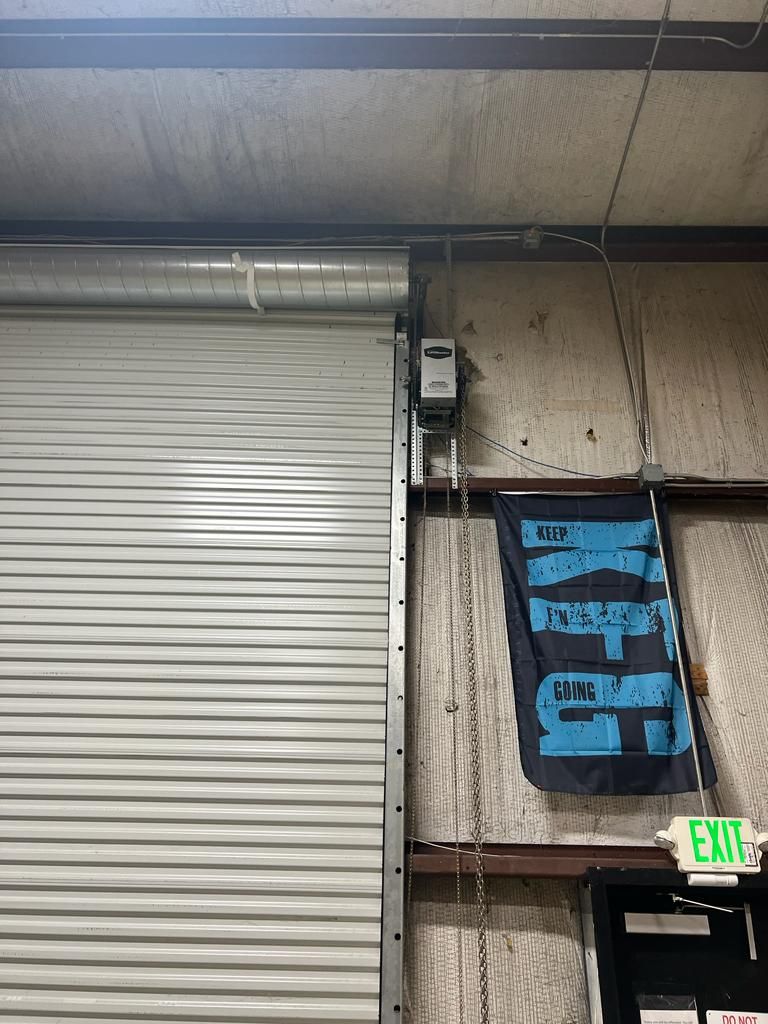 A garage door with a green exit sign on it.