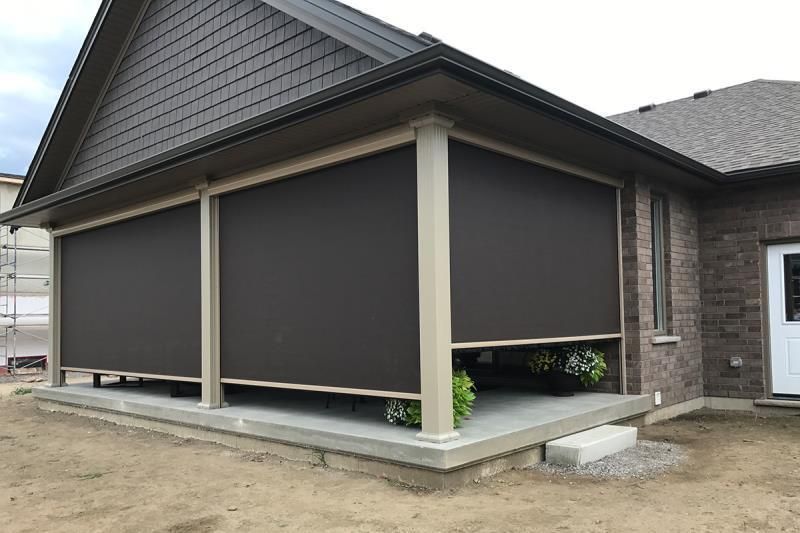 A house with a porch with shades on it.