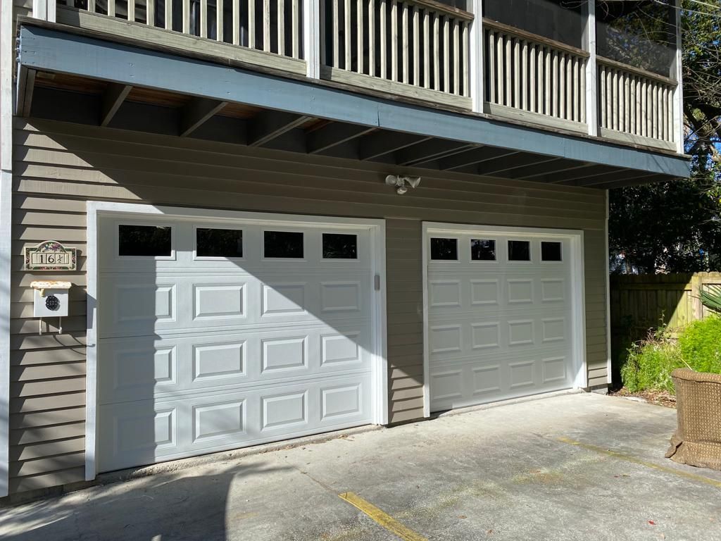 A house with two garage doors and a balcony