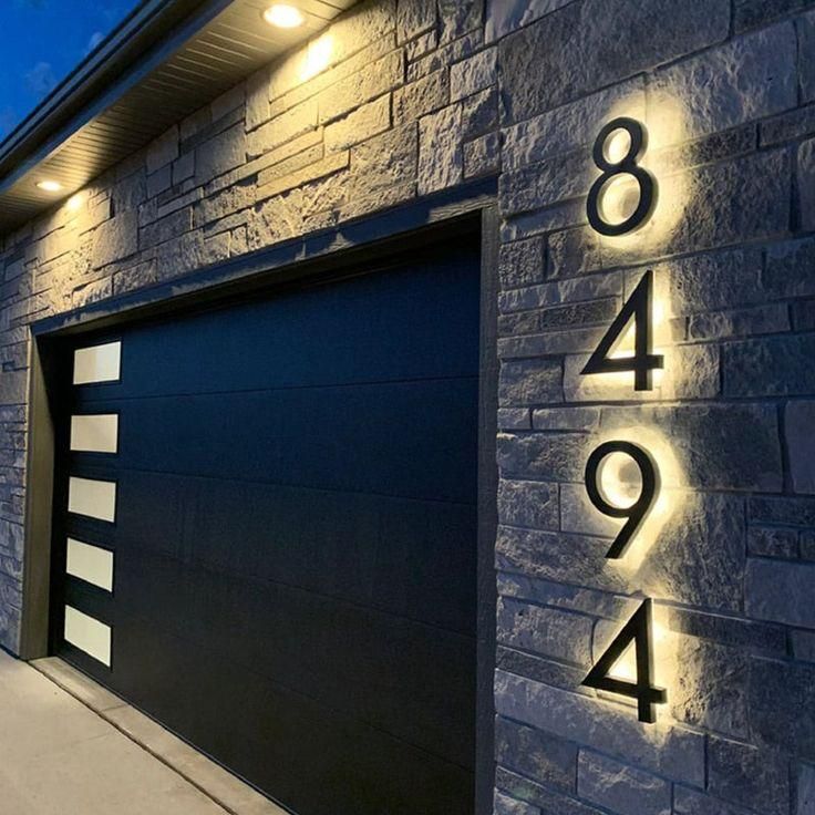 A black garage door with the numbers 8494 on it