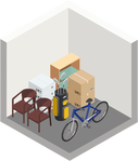 A room with a bicycle , chairs , boxes and a vacuum cleaner.