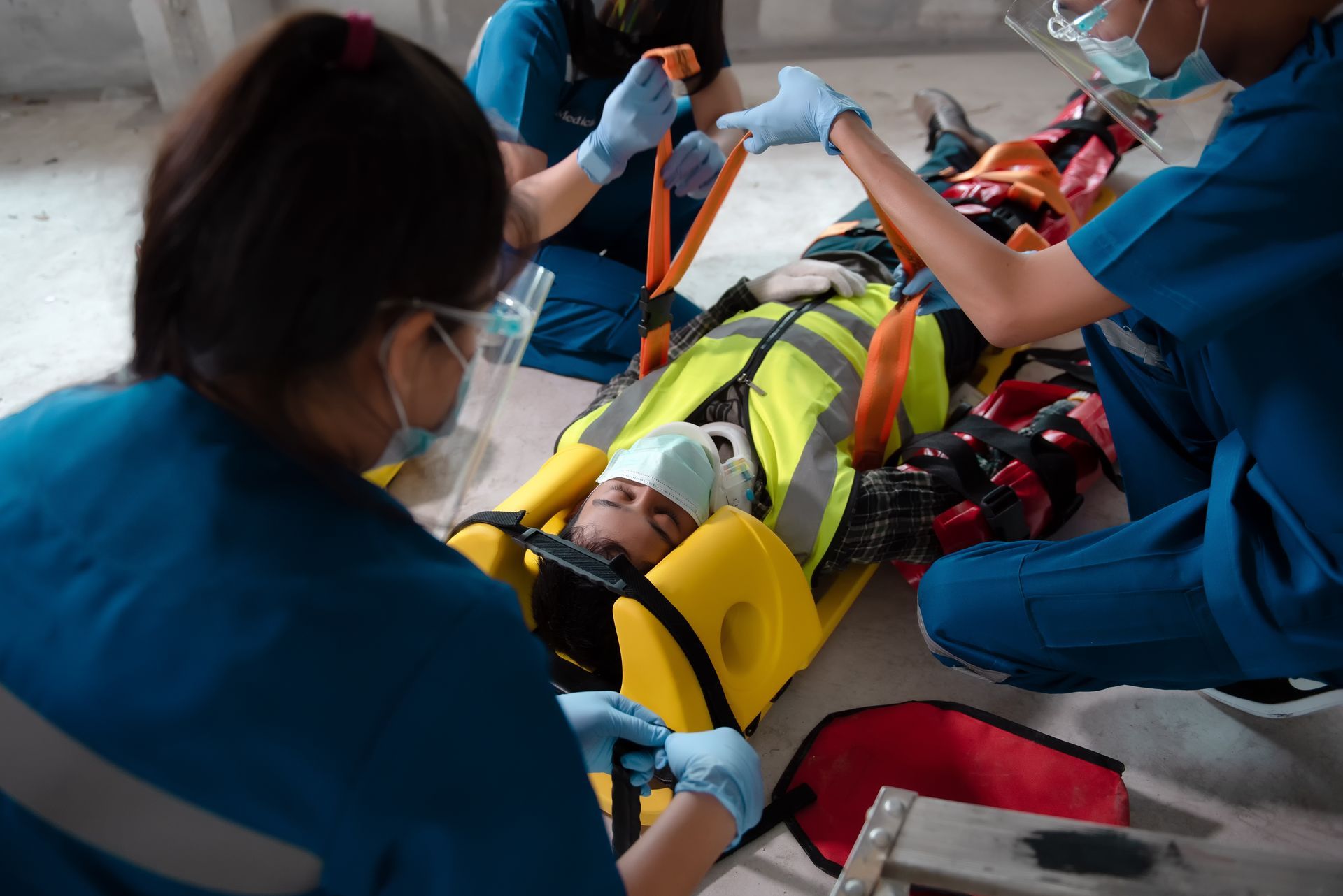 A person is laying on a stretcher with a bandage on their head.