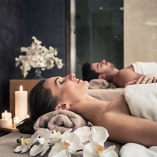 Man and Woman Lying Down on Massage Bed — Oceanport, NJ — Red Birch Spa
