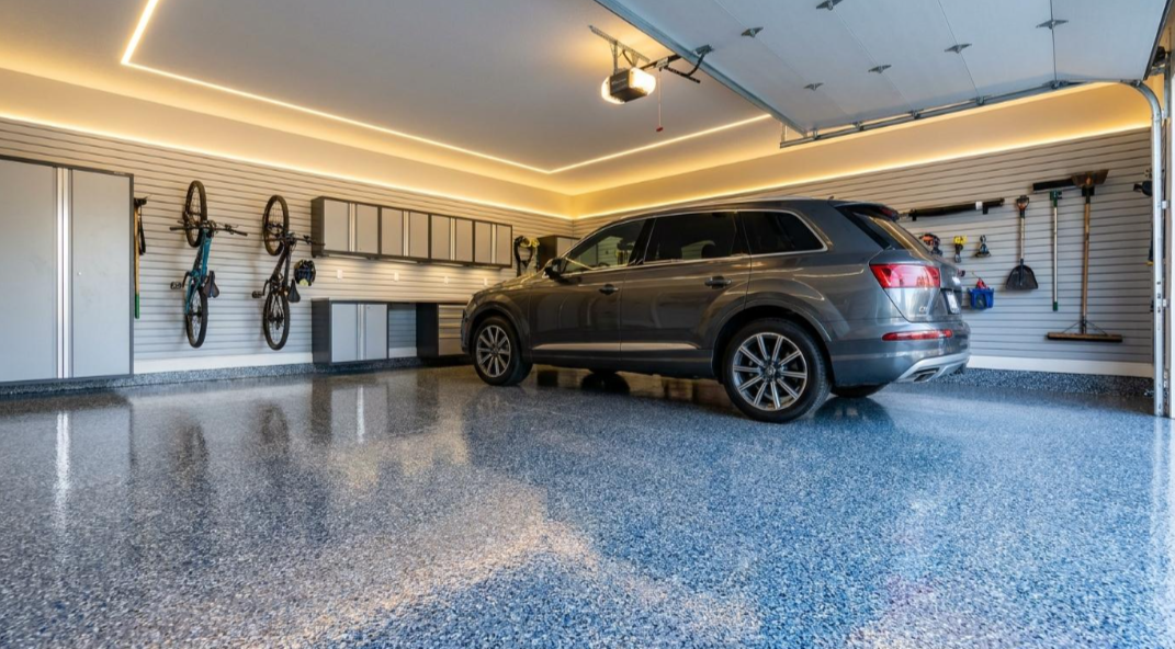 Gray SUV parked in a clean, well-lit garage with bicycles mounted on the wall.
