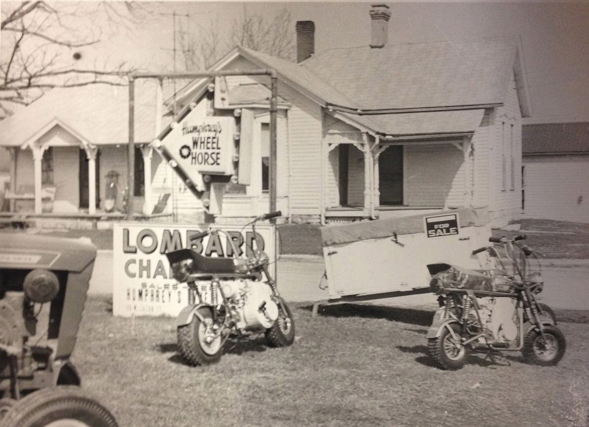 Mini bikes in front of a building with a sign for 