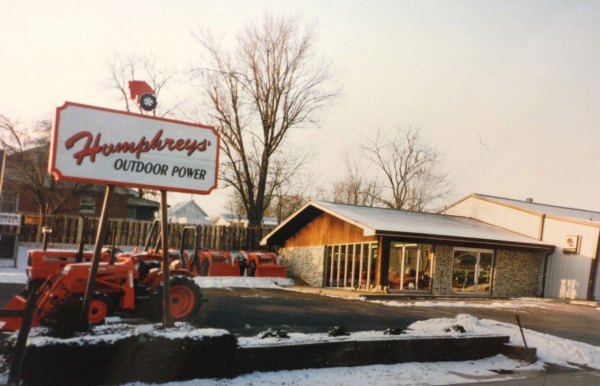 Humphreys Outdoor Power store in winter, sign with tractors, snowy exterior, cloudy sky.