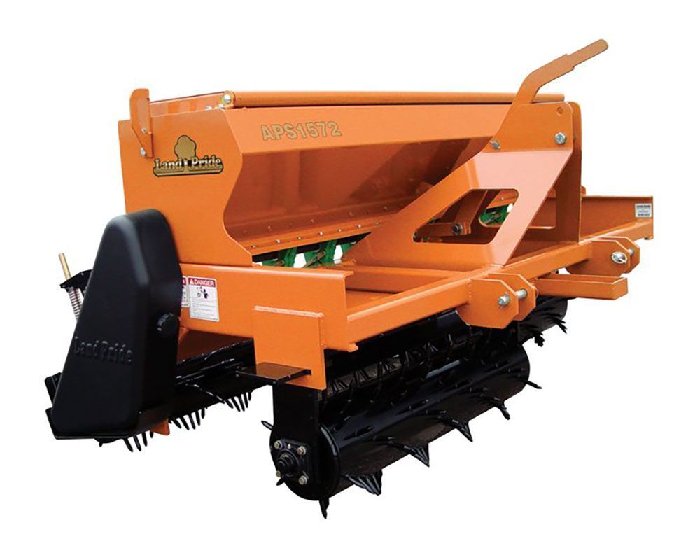 Orange seed drill with a hopper, seeding mechanism, and ground preparation tines.