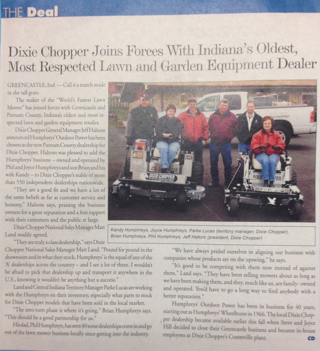 Article about Dixie Chopper and Hampton's, featuring people posing with lawnmowers outside a store.