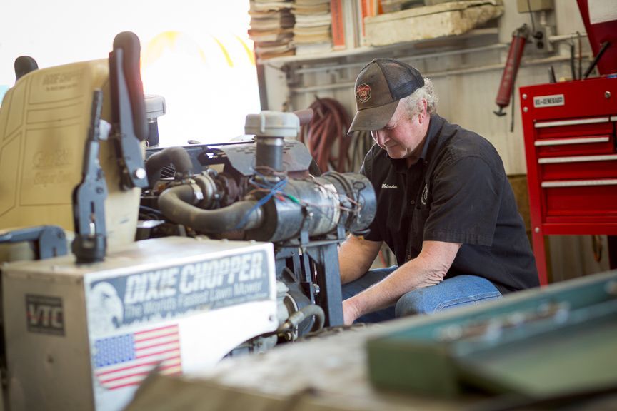 Man working on machinery in a garage.
