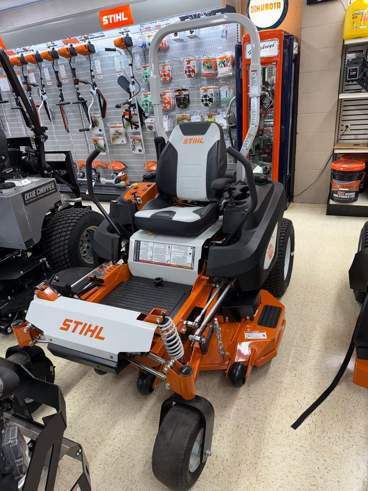 Orange and white Stihl zero-turn lawnmower on display in a store.