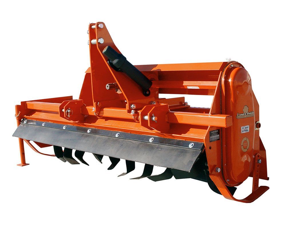 Orange tractor rotary tiller with blades and protective bar.