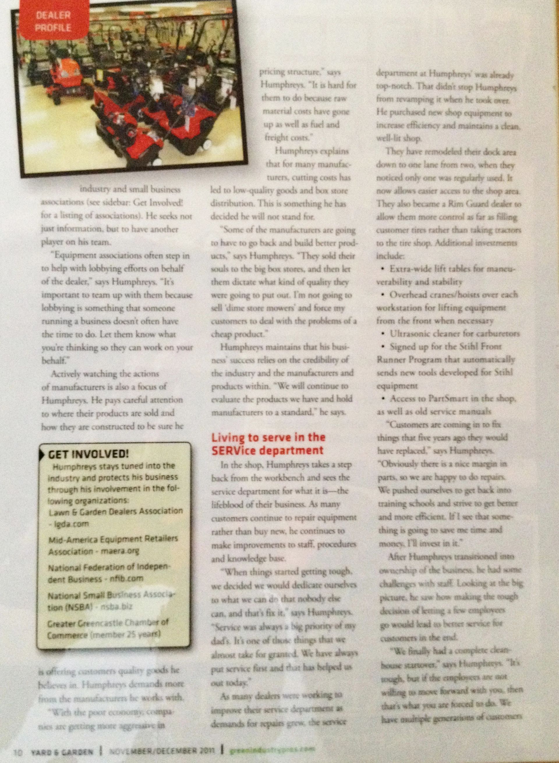 People in a factory setting, with multiple red-colored machines, and text article on the right.