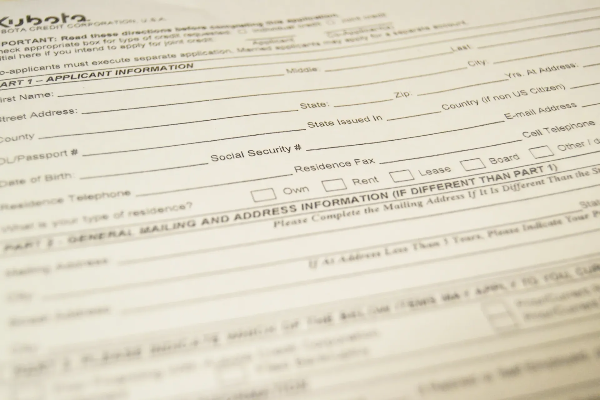 Close-up of a partially filled Kubota credit application form with handwritten information.