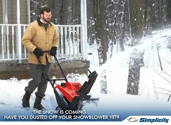 Man using a snowblower clears a snowy driveway. Text: