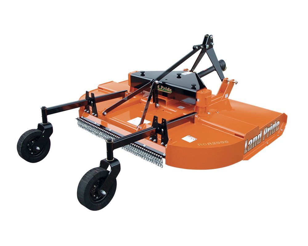 Orange tractor with a front loader and mower near a pond. A person operates the tractor on a grassy bank.