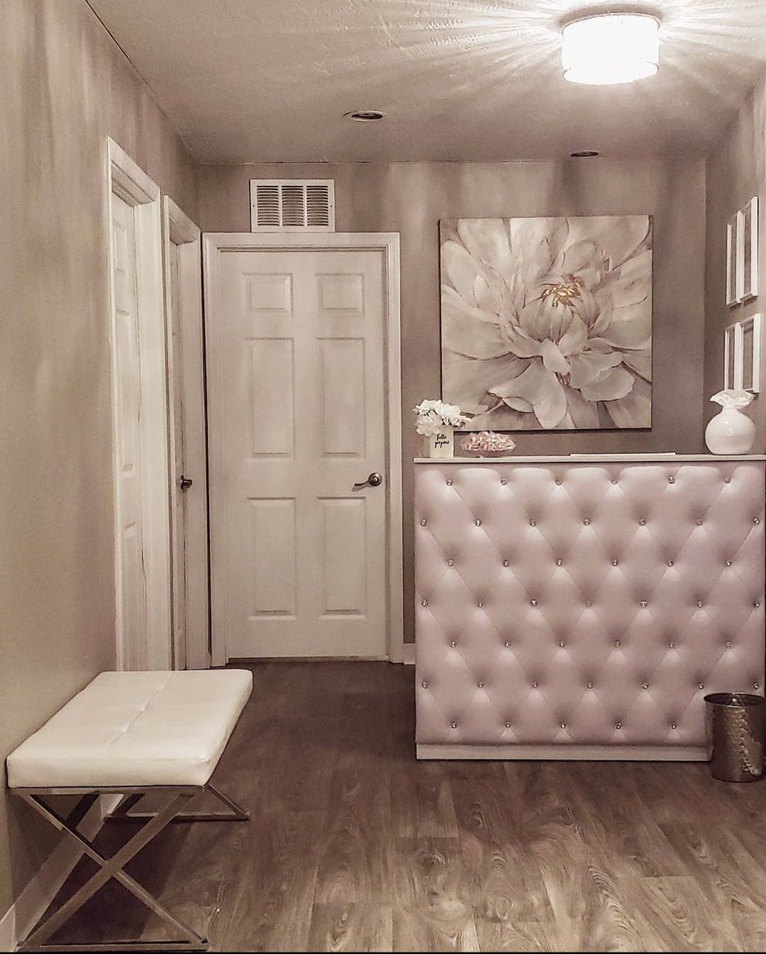 A hallway with a pink counter and a white bench
