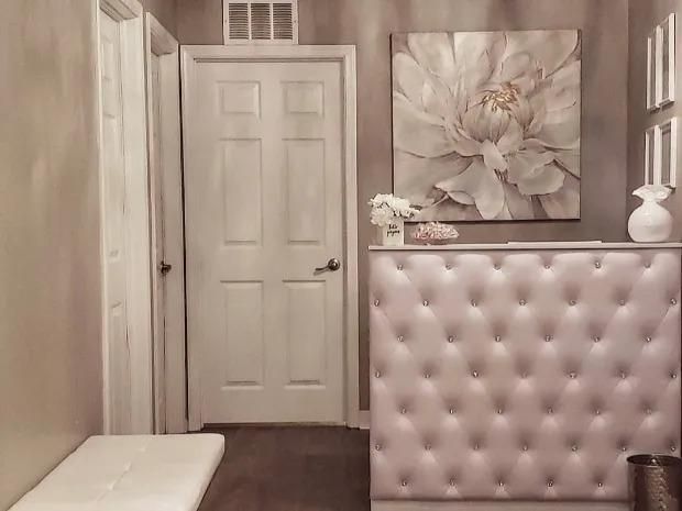 There is a painting of a flower on the wall above the counter.