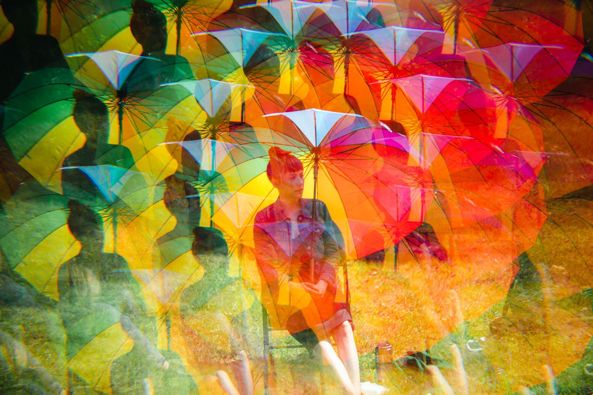 A person holding rainbow umbrella