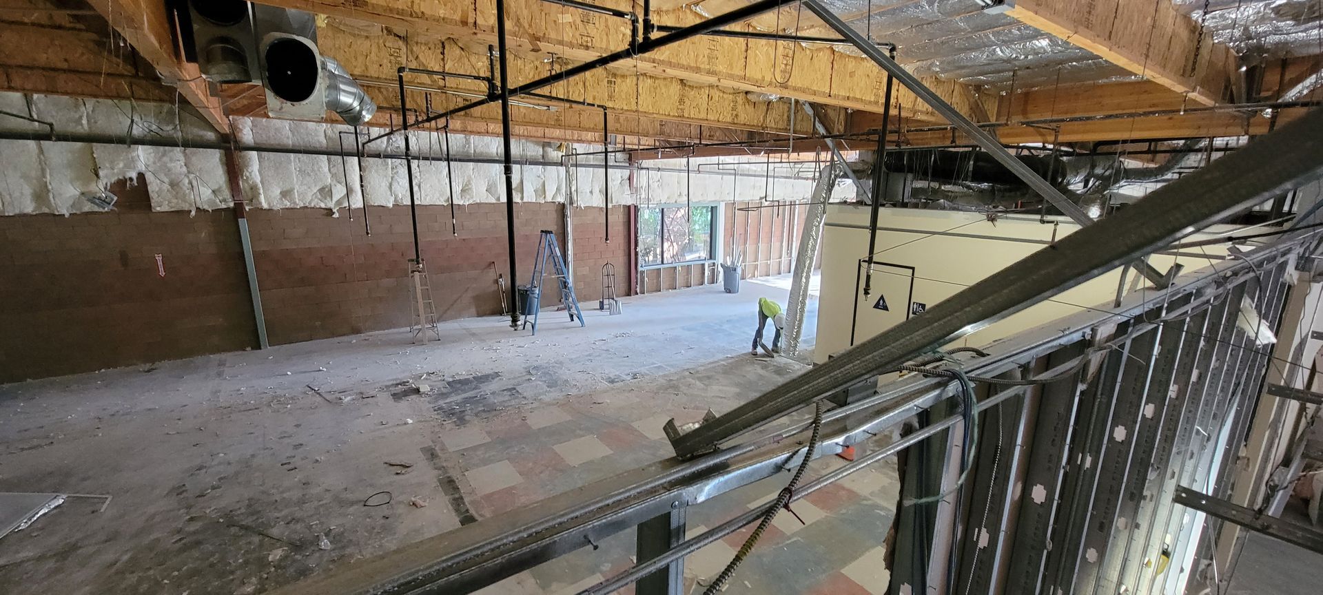 A ceiling of a building with a lot of wires hanging from it.