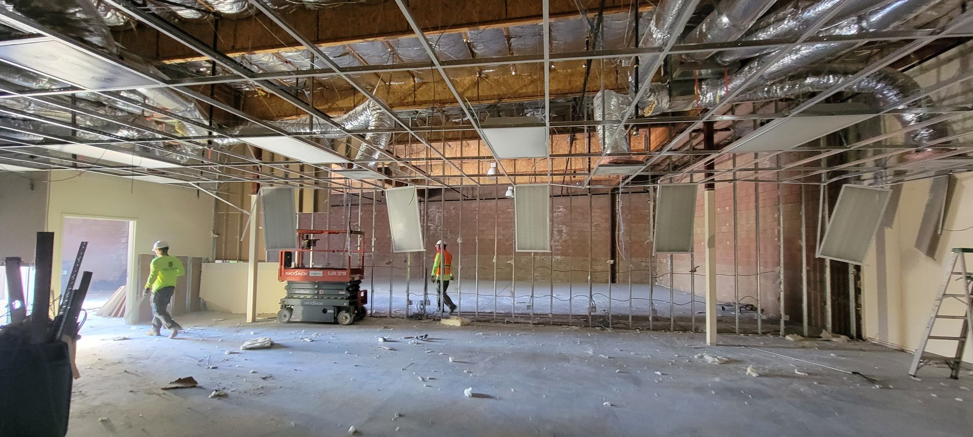 A large empty room with a ceiling that is being remodeled.