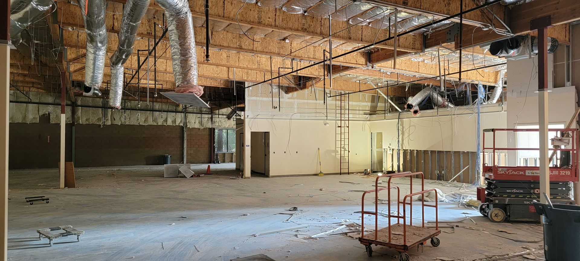 A large empty building under construction with a cart in the middle.