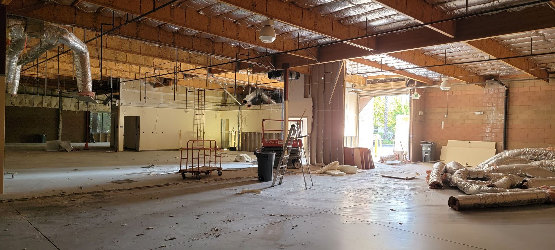 A large empty room with a ceiling that is being remodeled.