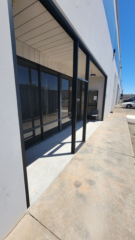 A building with a lot of windows and a walkway leading to it.