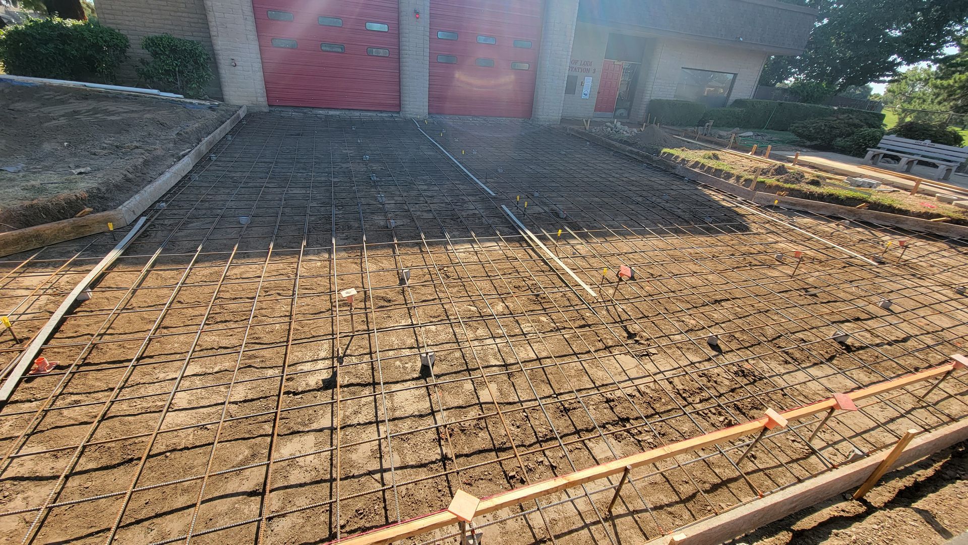A concrete driveway is being built in front of a house.