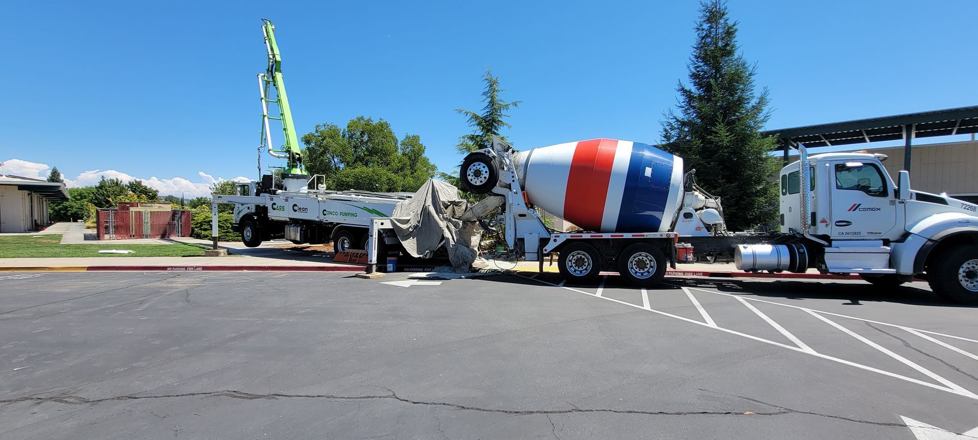 A concrete mixer truck is parked in a parking lot.