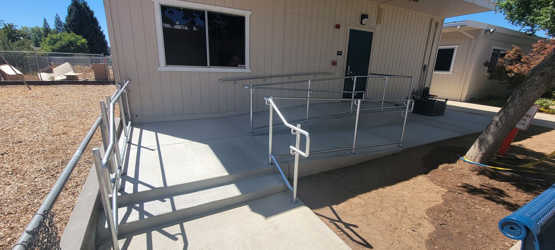 A house with a ramp and stairs leading to it.