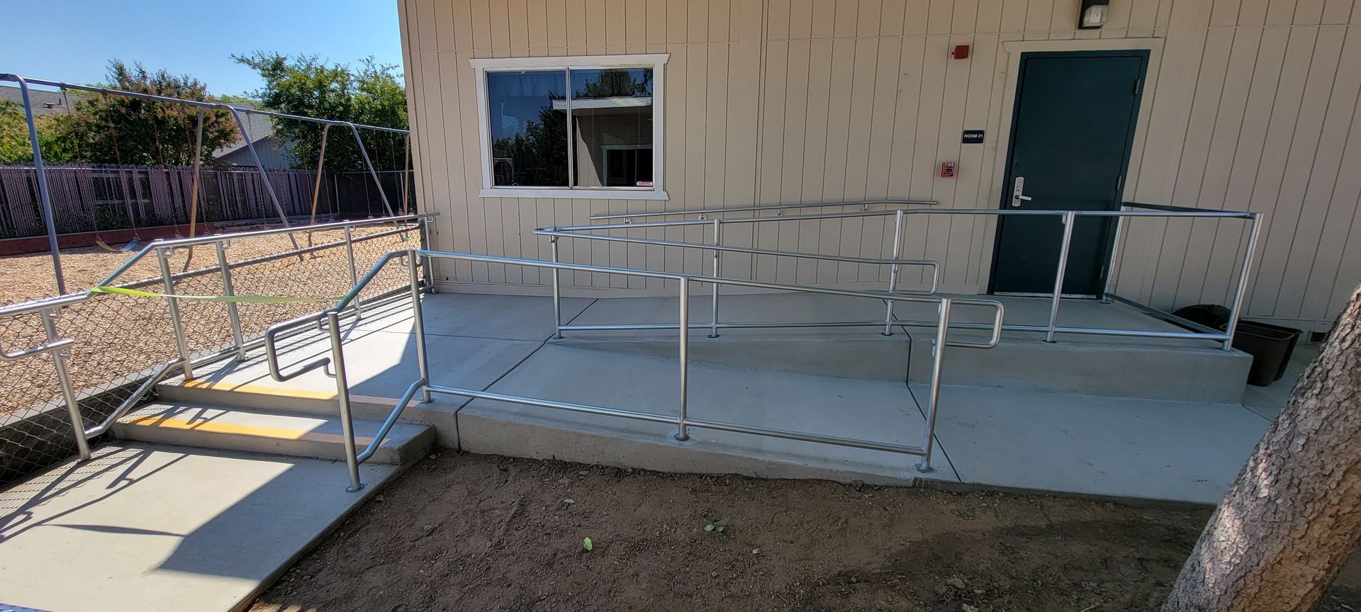 A house with a ramp and stairs leading up to it.