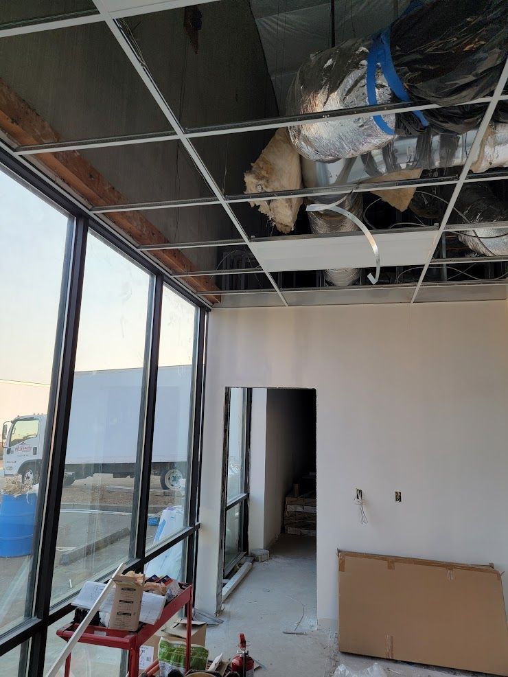 A room with a lot of windows and a ceiling that is being remodeled.