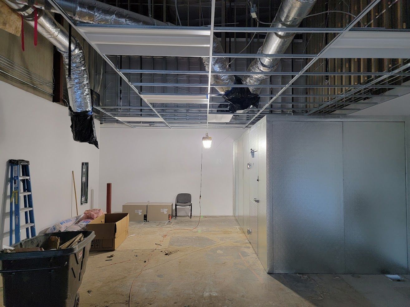 A large room with a ceiling that is being remodeled.