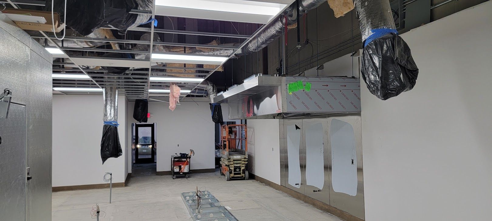 A large empty room with a ceiling that is being remodeled.