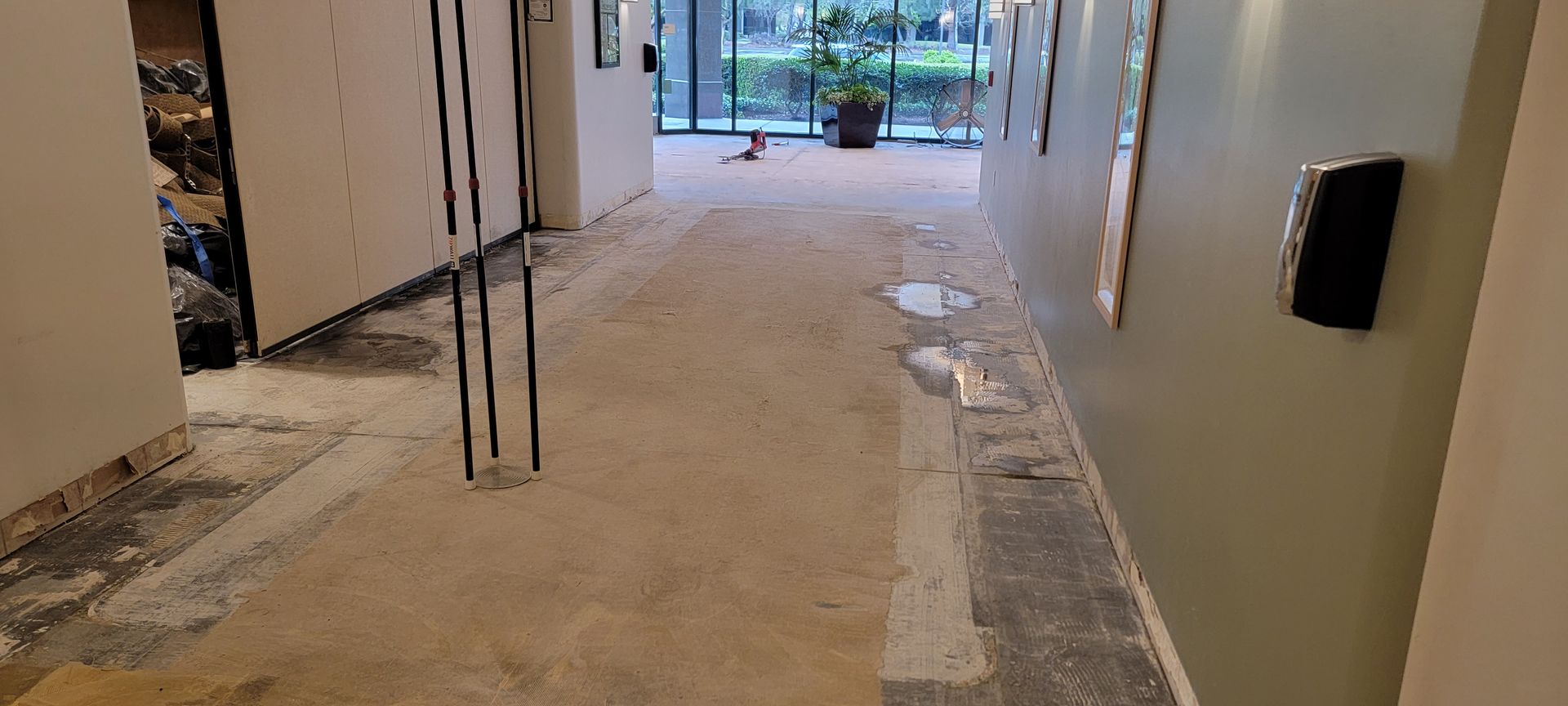 A long hallway with a lot of dirt on the floor.