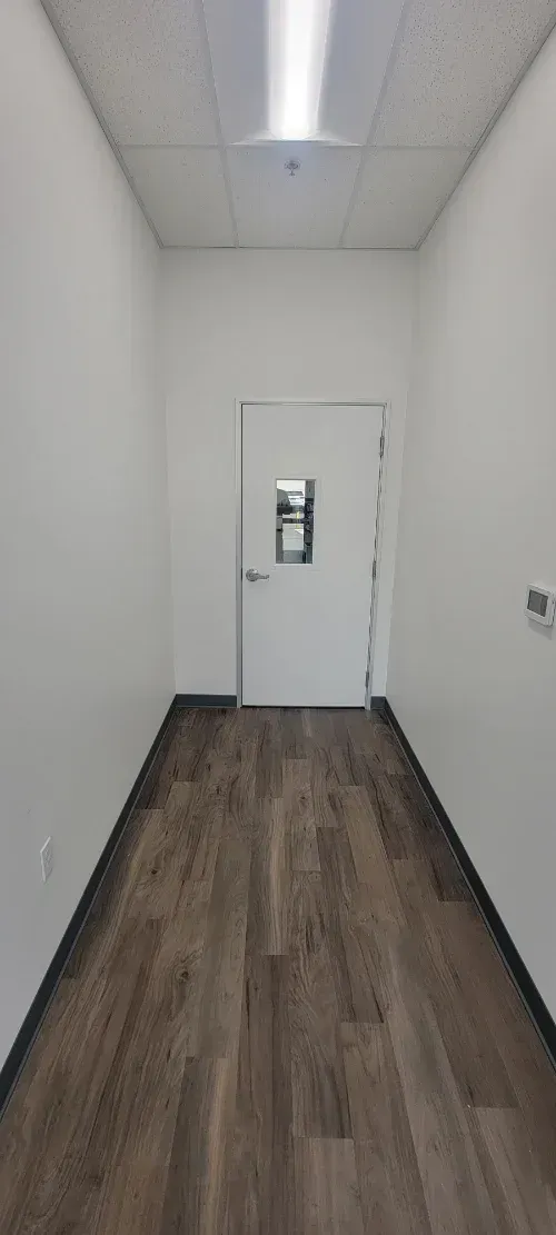 There is a door in the middle of the hallway.