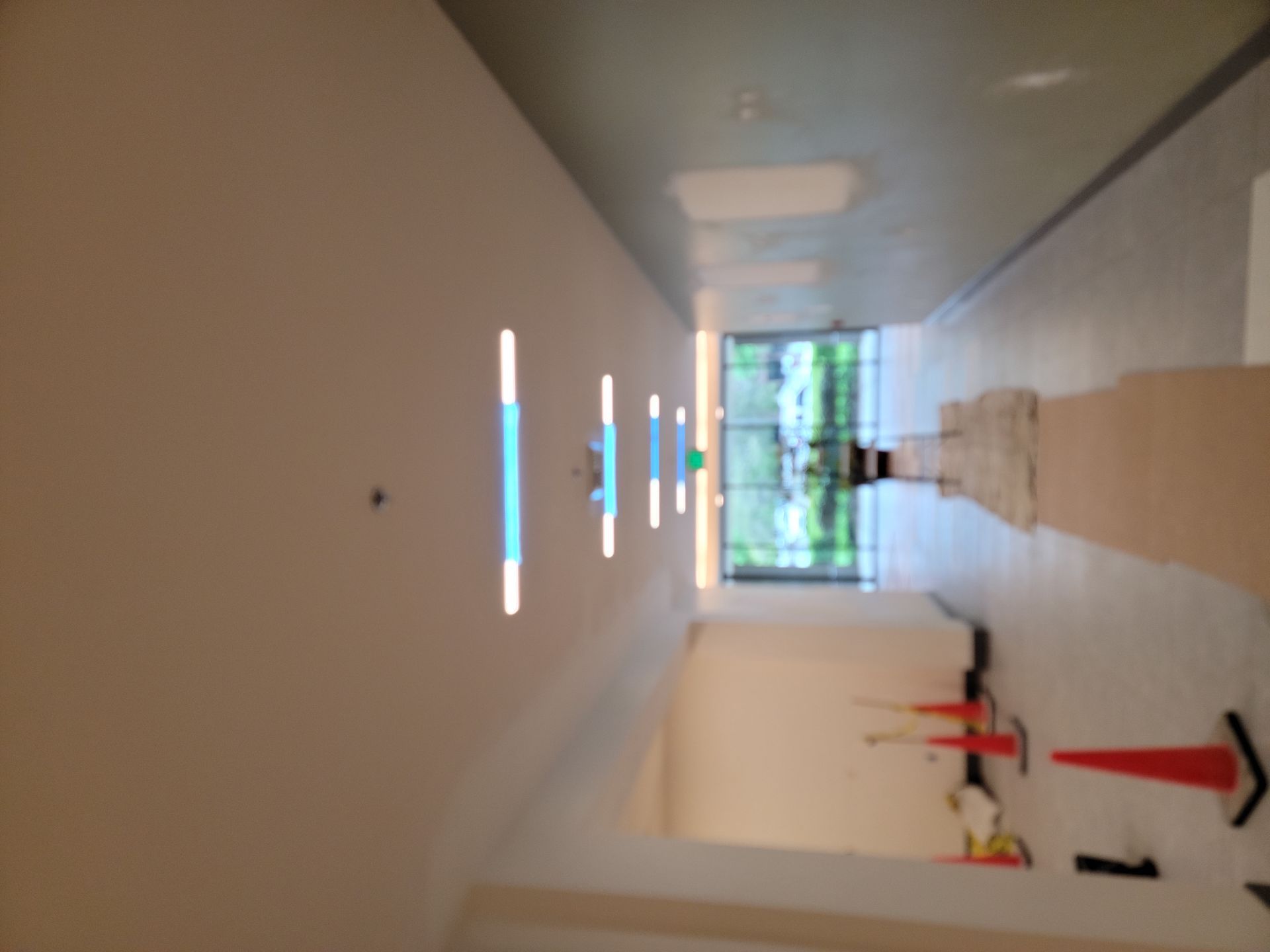 A hallway with a few lights on the ceiling