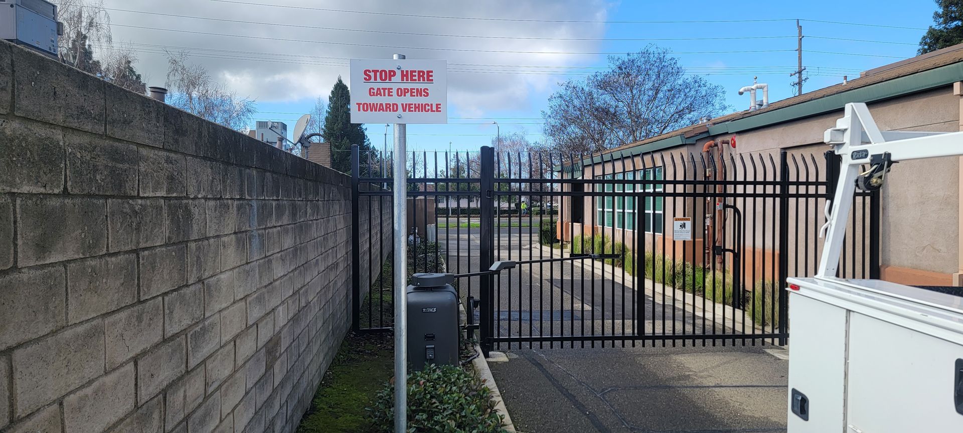 A fence with a gate and a sign on it.
