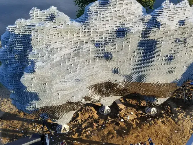 A large sculpture of a mountain is sitting on top of a pile of dirt