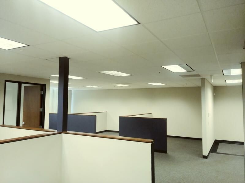 An empty office with cubicles and a door