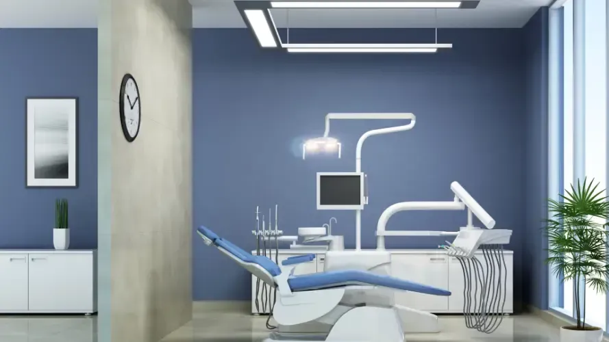A dental office with a dental chair and a clock on the wall.