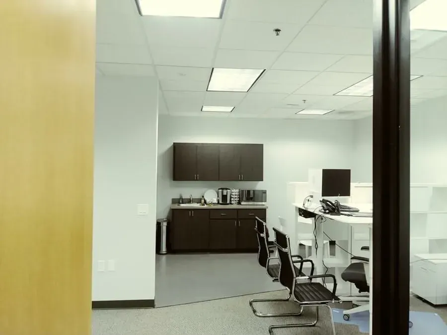 A room with a lot of chairs and cabinets in it