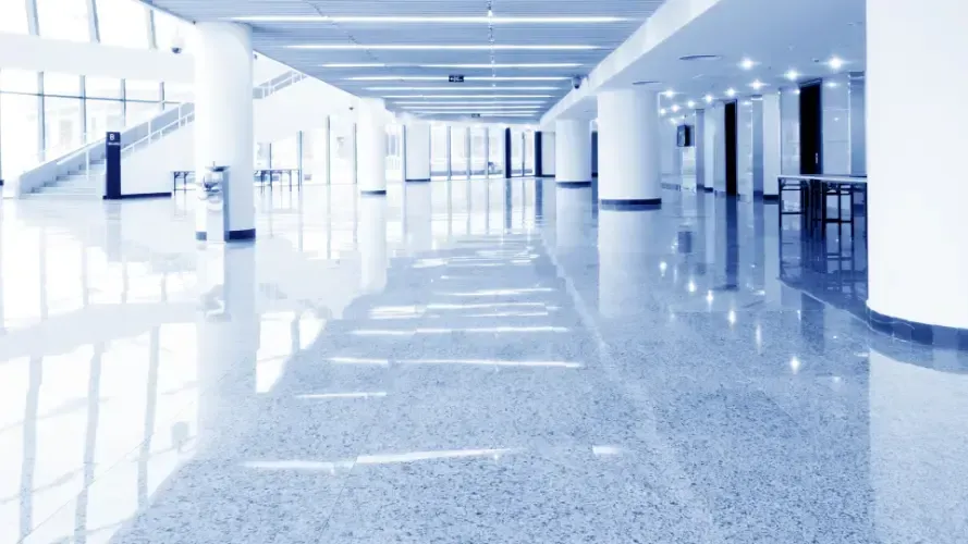 A large office space in a building with a lot of doors and walls.