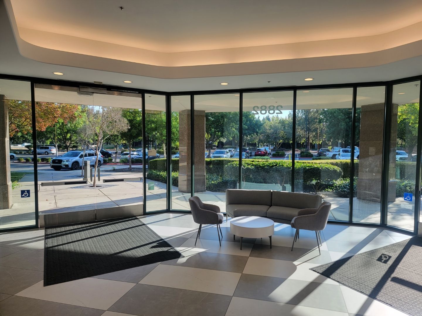 A lobby with a couch , chairs , and a table.