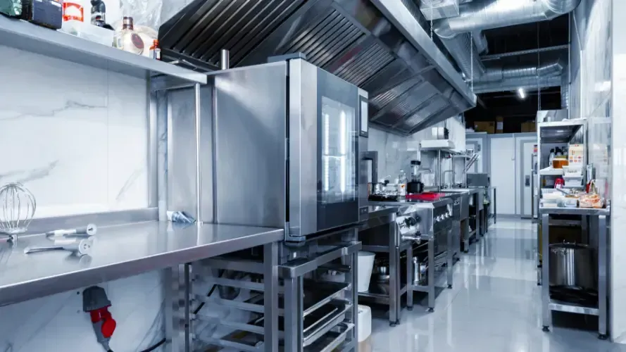 A kitchen with a lot of stainless steel appliances and equipment.