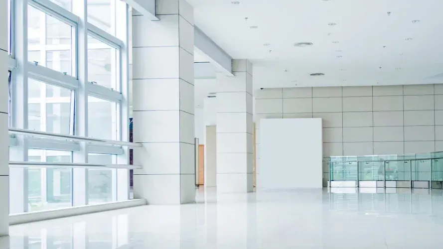 Tenant Improvement: Large commercial space with windows and walls.