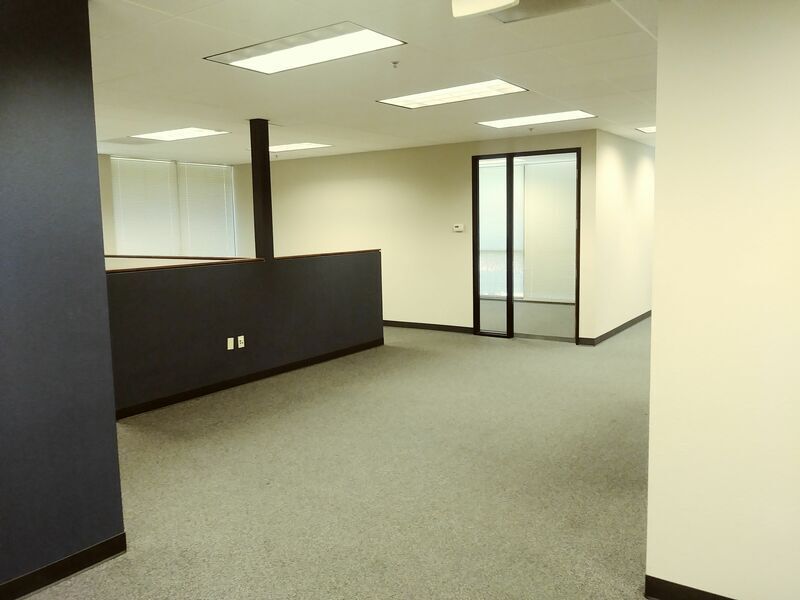 A large empty room with a sliding glass door